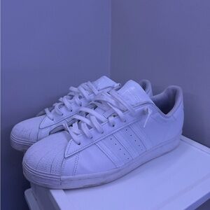 All white Adidas Superstars